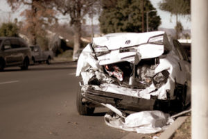 A car that has been smashed in the road.
