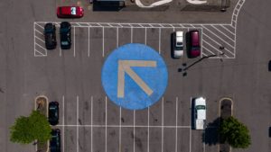 A parking lot with an arrow painted on the ground.